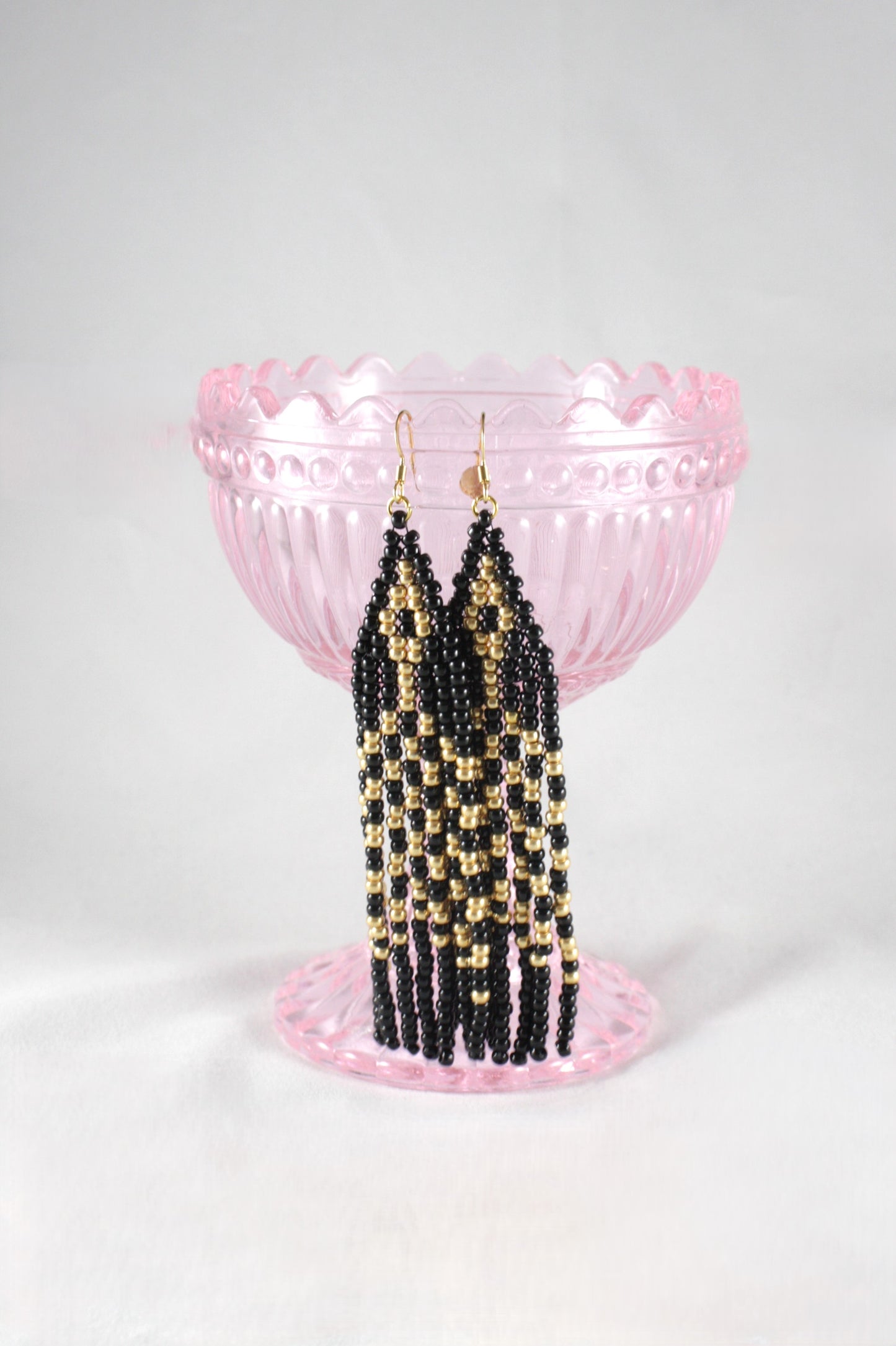 Handwoven fringe seed bead earrings made of small glass beads. Colors are black and gold. Käsintehdyt hapsulliset lasihelmikorvakorut. Väreinä musta ja kulta.
