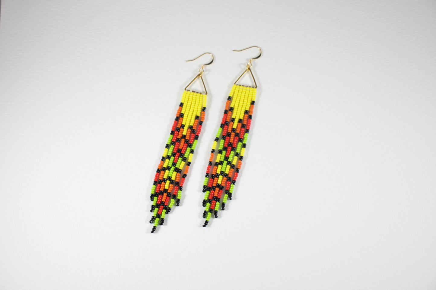 Long seed bead fringe earrings multicolor, yellow, orange, red, light green and black stripes. Gold plated earrings hooks and triangle links.