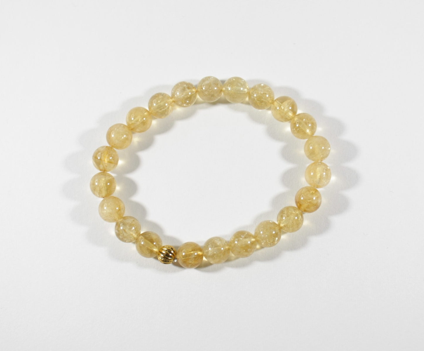 Yellow citrine stretch bracelet with one gold color bead. Keltainen sitriini joustorannekoru yhdellä kullanvärisellä helmellä.
