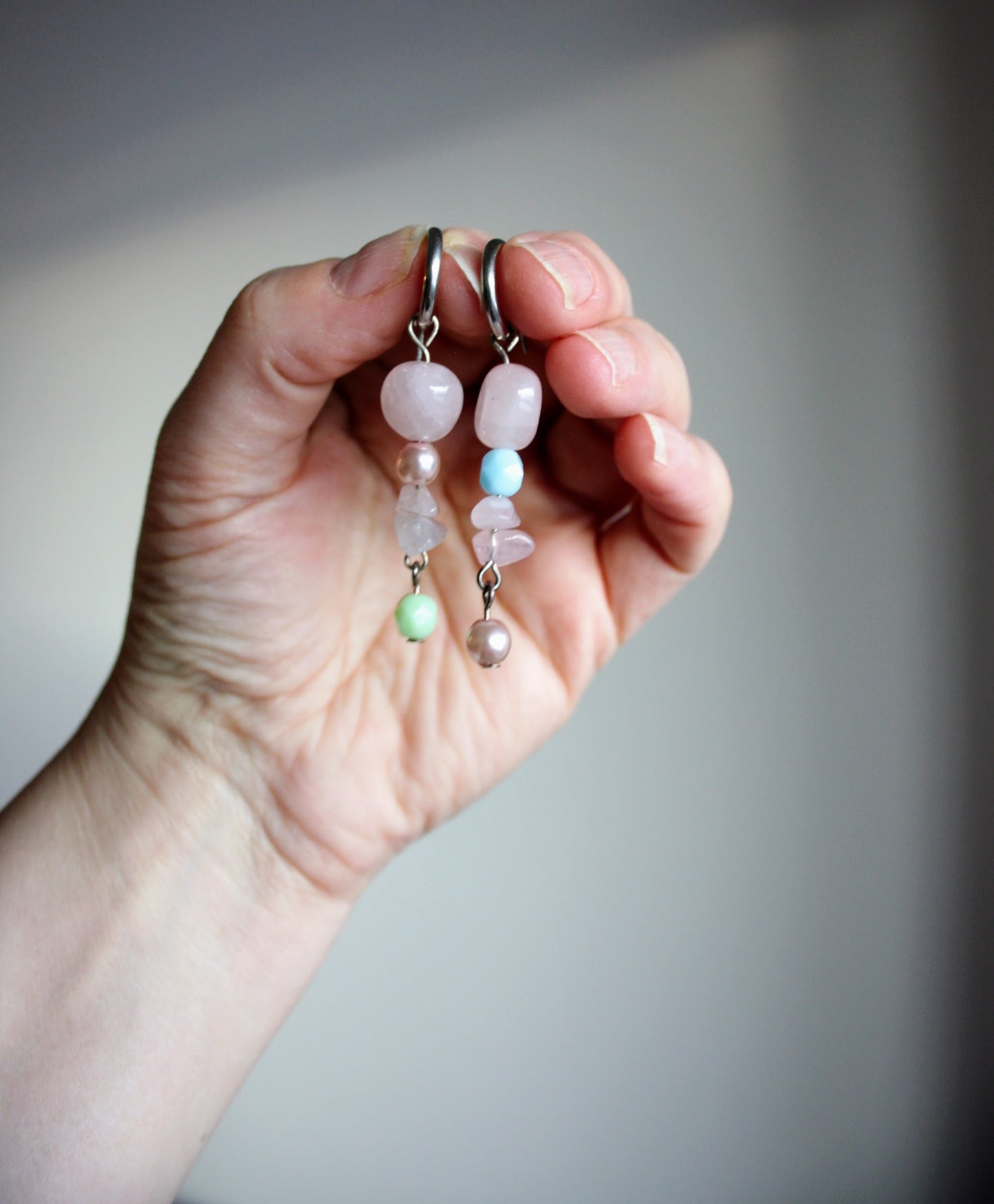 Handmade dangle rose quartz earrings with stainless steel earrings hoops. Käsintehdyt roikkuvat ruusukvartsi korvakorut, joissa on ruostumattomasta teräksestä tehdyt korvakorurenkaat.