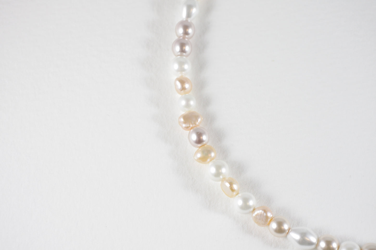 Freshwaterpearl nuggets and different glass beads choker necklace. Color is light peach and white and choker has silver color clasp and extension chain.