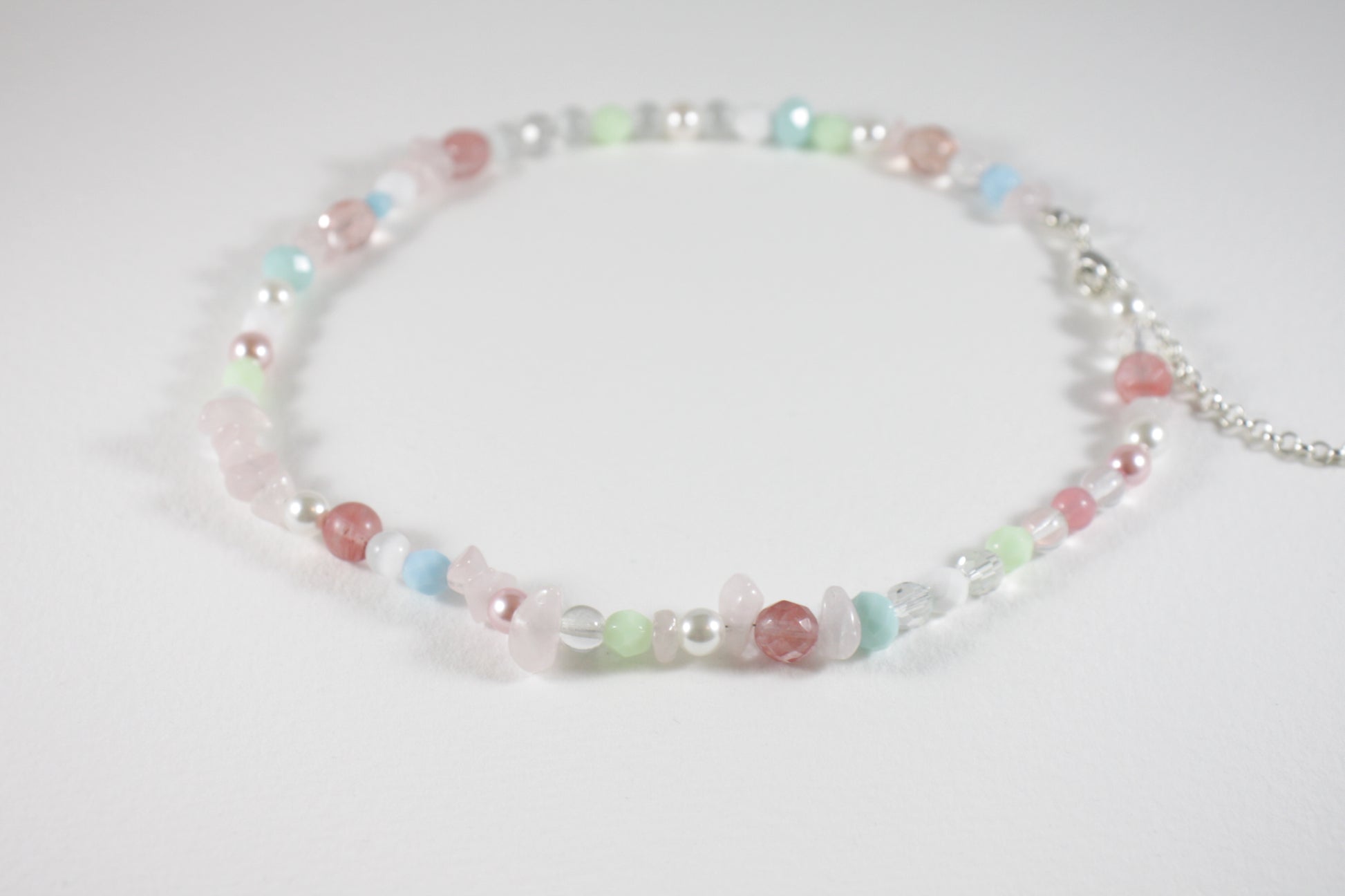 Rose quartz chips choker necklace with different glass beads pastel colors and silver color clasp and chain.