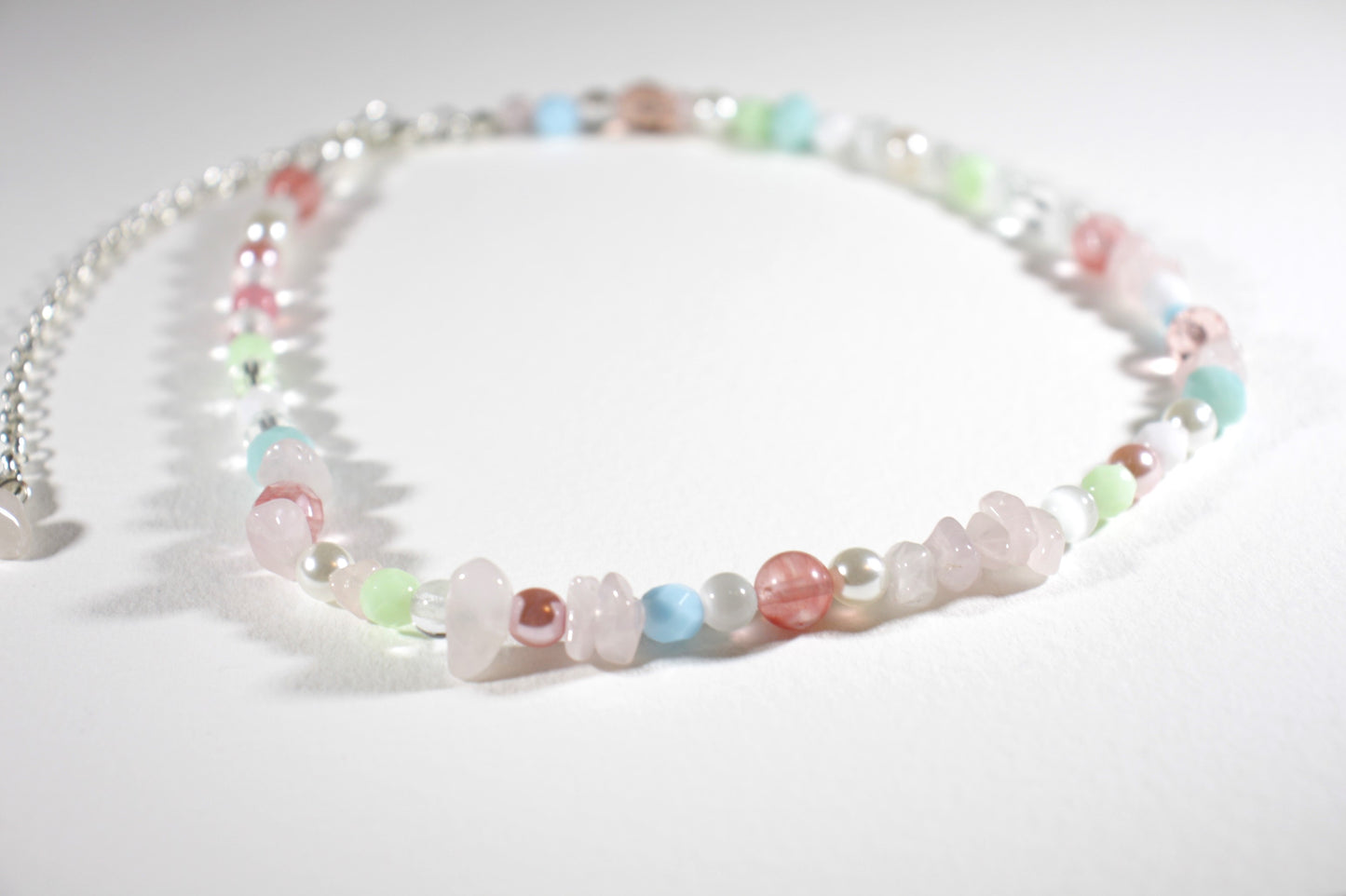 Rose quartz chips choker necklace with different glass beads pastel colors and silver color clasp and chain.