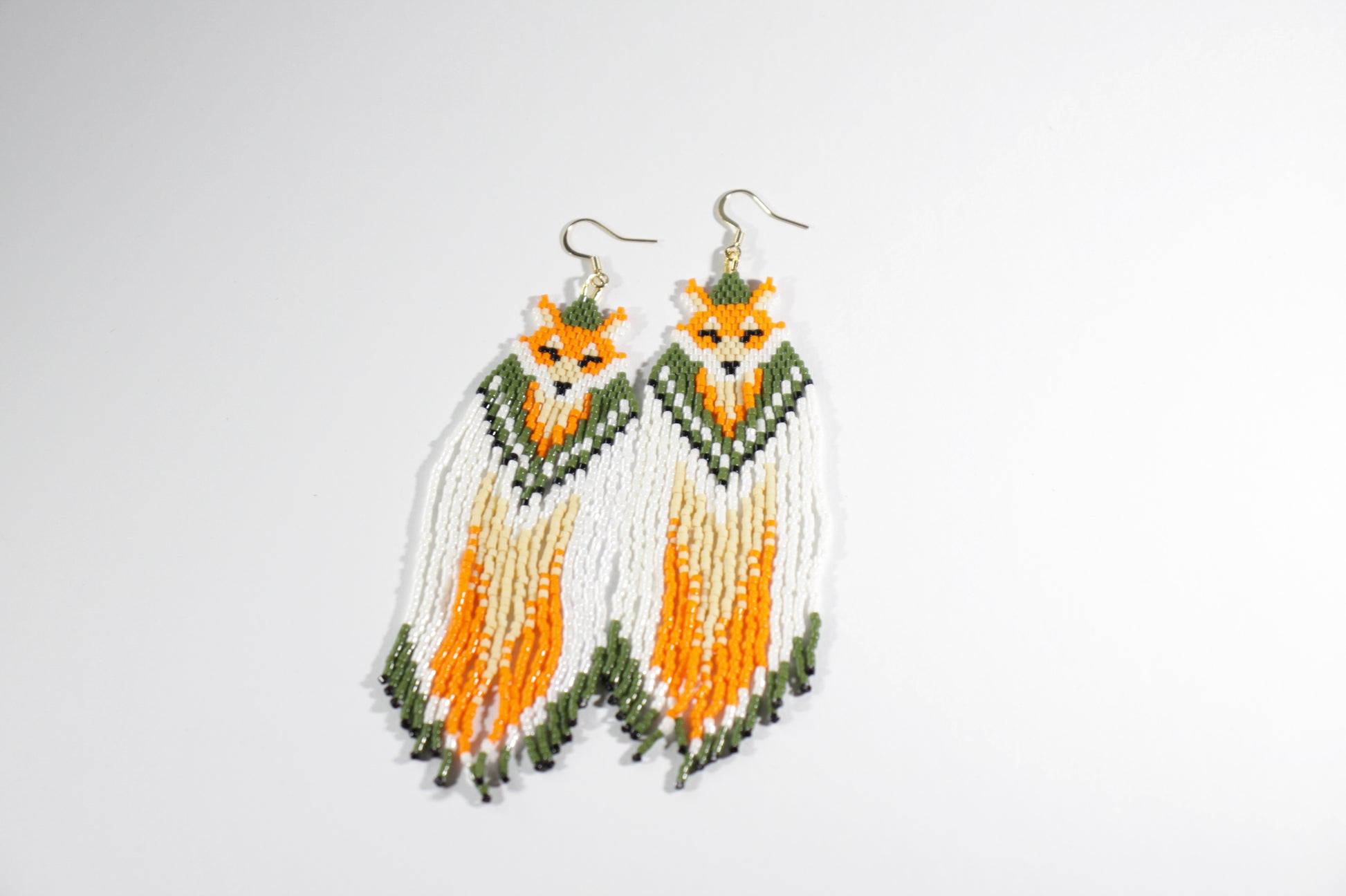 Long handmade seed bead fringe earrings foxes  with green and orange color. Pitkät roikkuvat hapsulliset käsintehdyt kettu helmikorvakorut väreinä oranssi-vihreä.