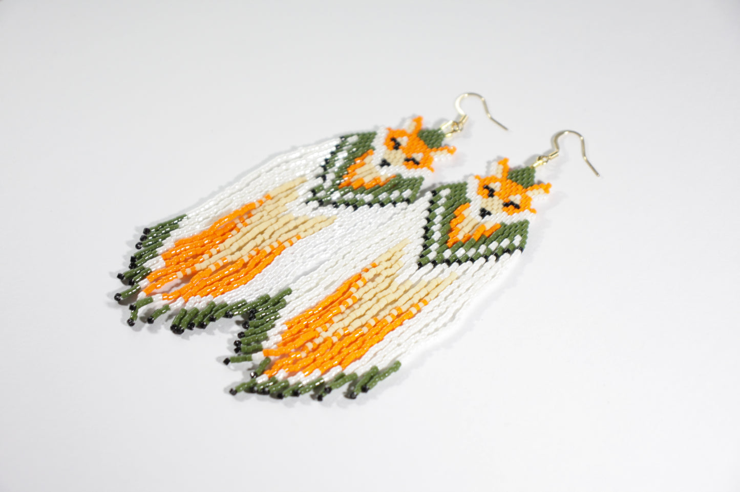 Long handmade seed bead fringe earrings foxes  with green and orange color. Pitkät roikkuvat hapsulliset käsintehdyt kettu helmikorvakorut väreinä oranssi-vihreä.