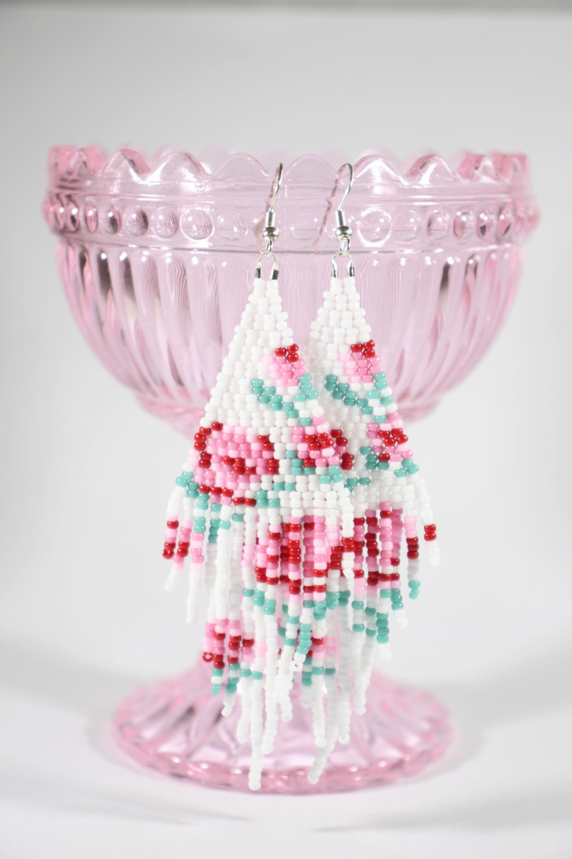 Long beaded seed bead fringe earrings. Base color of these earrings is white and has red and pink roses pattern. Pitkät käsintehdyt roikkuvat helmikorvakorut. Pohjaväri näissä korvakoruissa on valkoinen sekä, kuviona on punaisia ja pinkkejä ruusuja.  