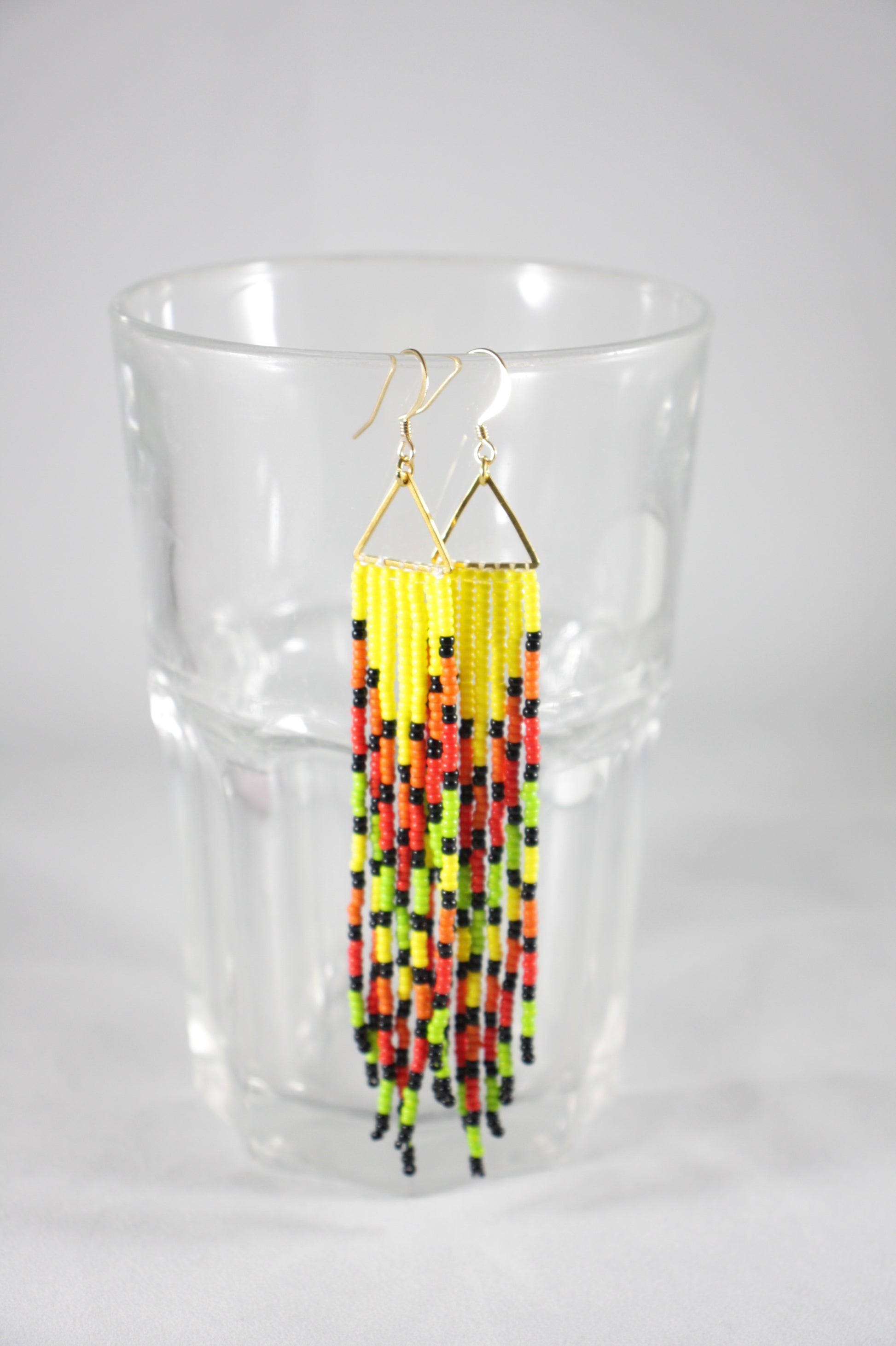 long seed bead fringe earrings multicolor, yellow, orange, red, light green and black stripes. Gold plated earrings hooks and triangle links.