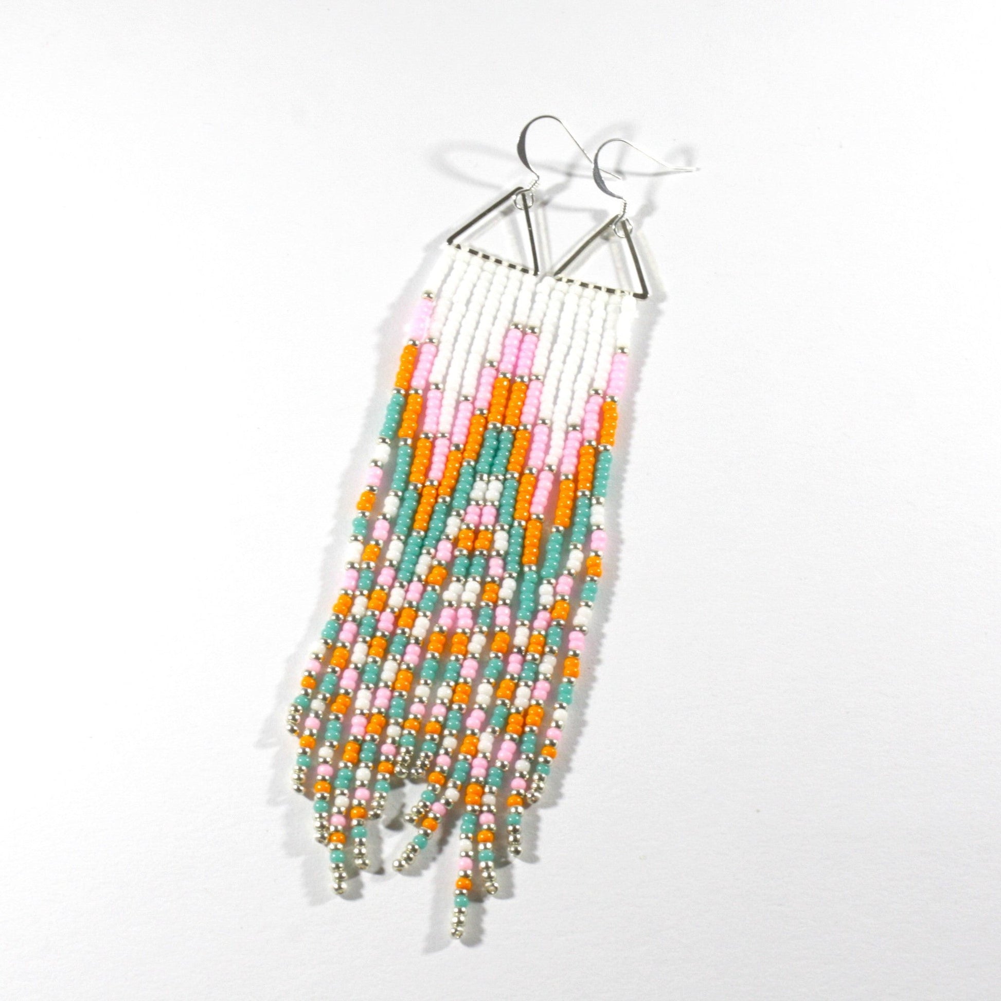 Long fringe seed bead earrings with silver color triangle links and hooks. Fringe color are white, pink, orange and turquoise with silver color beads in between.