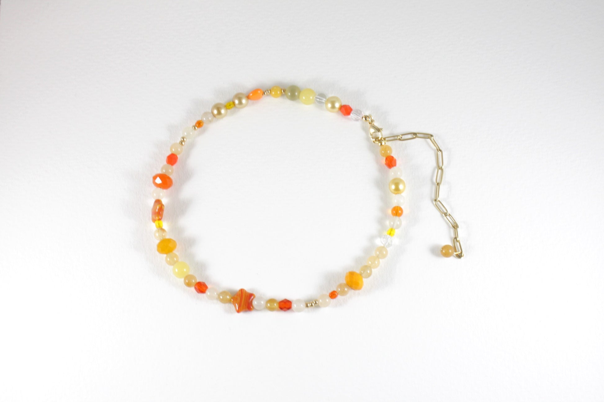 Sitrine beads size of 6 mm and different size of glass beads choker necklace orange and yellow colors. Clasp and extension chains are gold colors. 