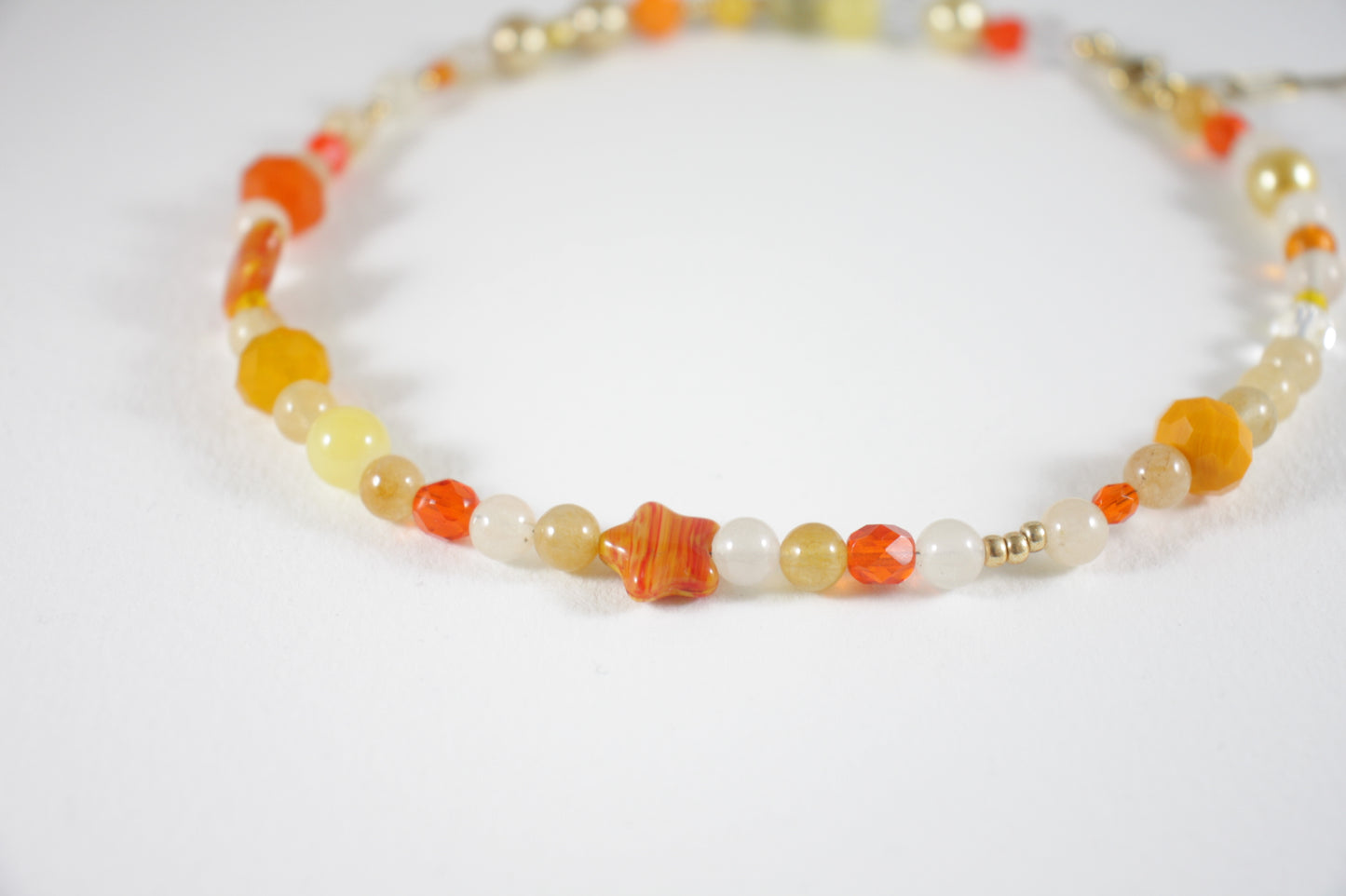 Sitrine beads size of 6 mm and different size of glass beads choker necklace orange and yellow colors. Clasp and extension chains are gold colors. 